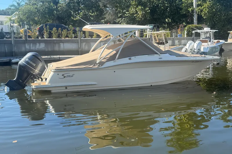 The Image of 2019 Scout 255 Dorado boat with Yamaha engine docked in calm waters. - 0