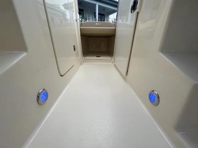 Slide: The Image of Interior of a 2019 Scout 255 Dorado boat with blue LED lighting. - 14
