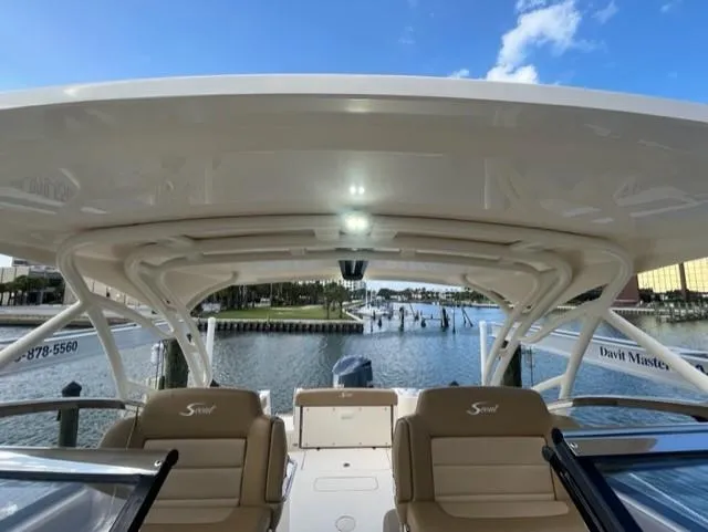 Slide: The Image of 2019 Scout 255 Dorado boat with covered deck and water view. - 15