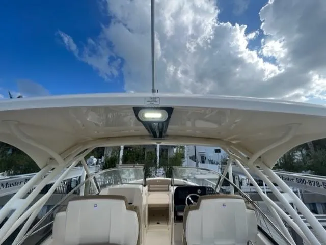 Slide: The Image of 2019 Scout 255 Dorado with open canopy and cloudy sky. - 19