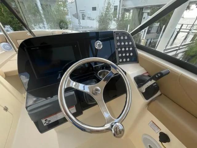 Slide: The Image of 2019 Scout 255 Dorado boat helm with steering wheel and controls. - 3