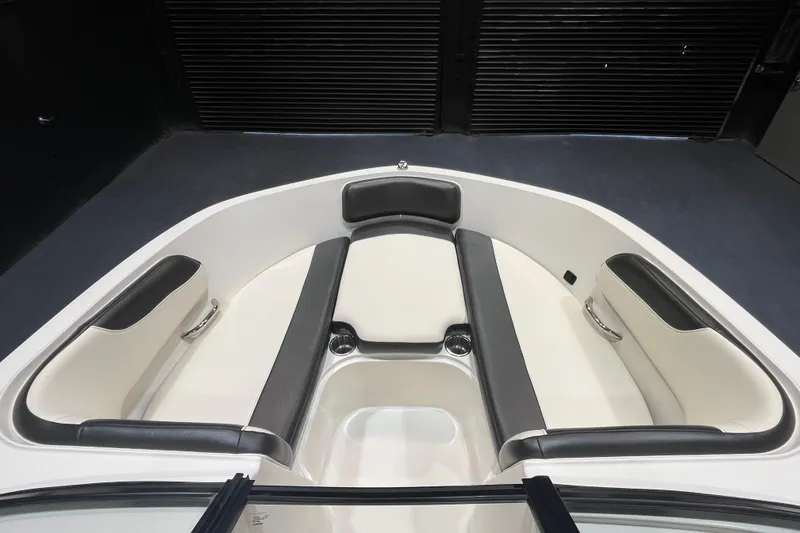Slide: The Image of 2022 Bayliner VR6 Bowrider OB interior with cushioned seating and sleek design. - 11