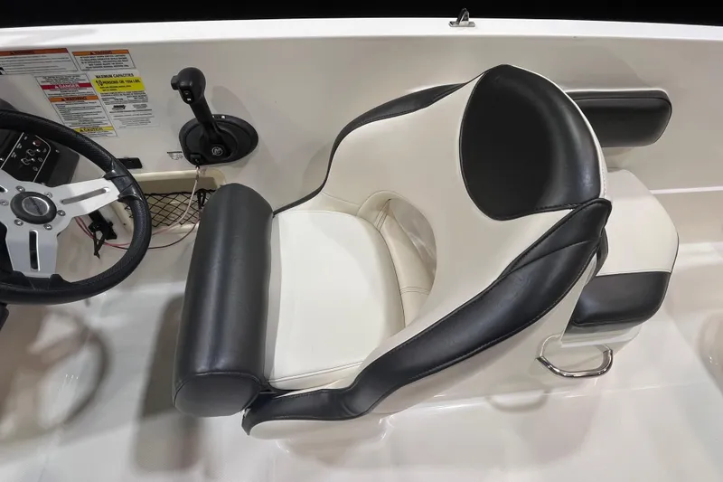 Slide: The Image of 2022 Bayliner VR6 Bowrider OB cockpit with steering wheel and cushioned seat. - 9
