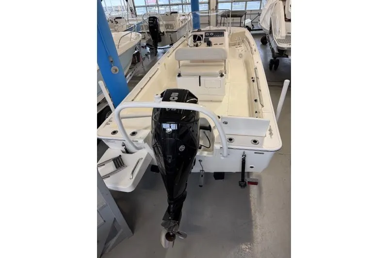 The Image of 2024 Boston Whaler 210 Montauk boat with outboard motor in showroom. - 0