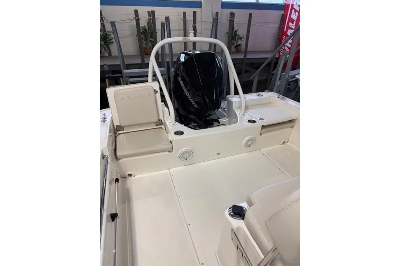 Slide: The Image of 2024 Boston Whaler 210 Montauk boat interior with seating and engine view. - 13