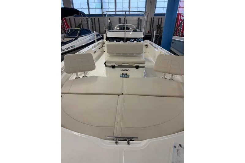 Slide: The Image of 2024 Boston Whaler 210 Montauk boat interior with seating and Igloo cooler. - 16