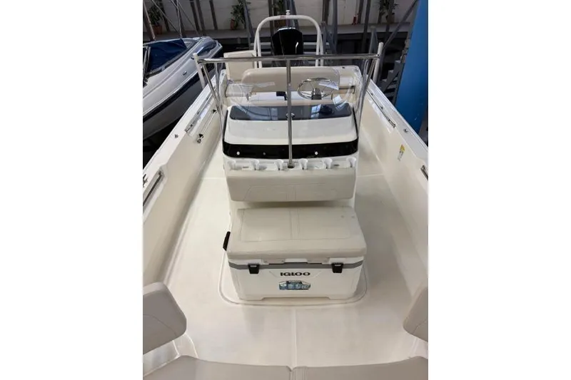 Slide: The Image of 2024 Boston Whaler 210 Montauk interior with Igloo cooler and seating arrangement. - 2