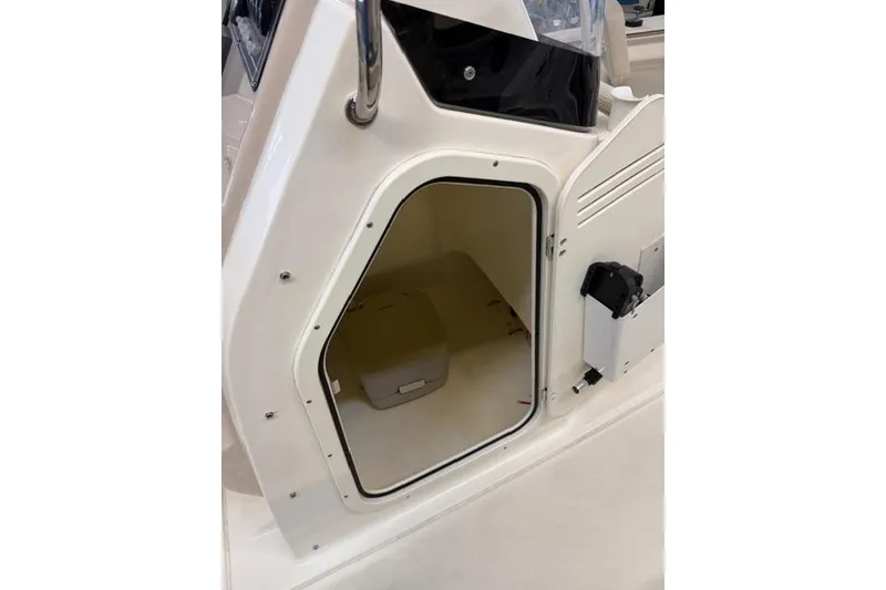 Slide: The Image of 2024 Boston Whaler 210 Montauk storage compartment with open door. - 3