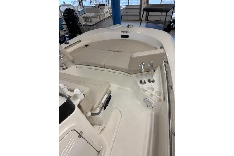 Slide: The Image of 2024 Boston Whaler 210 Montauk boat interior with cushioned seating and storage. - 4