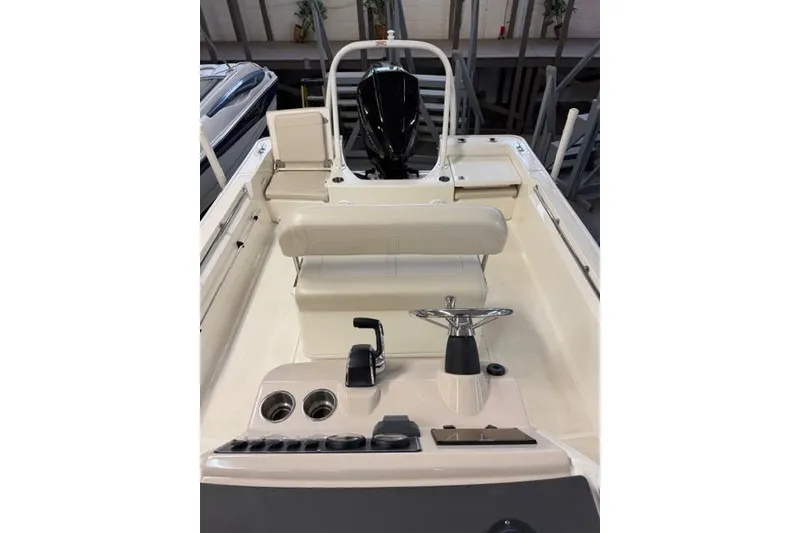 Slide: The Image of 2024 Boston Whaler 210 Montauk boat interior with steering console and seating. - 8