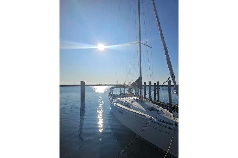 Slide: The Image of 2023 Jeanneau Sun Odyssey 349 sailboat docked under bright sun. - 1