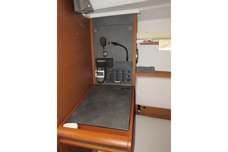 Slide: The Image of 2023 Jeanneau Sun Odyssey 349 navigation station with Raymarine equipment and wooden finish. - 10