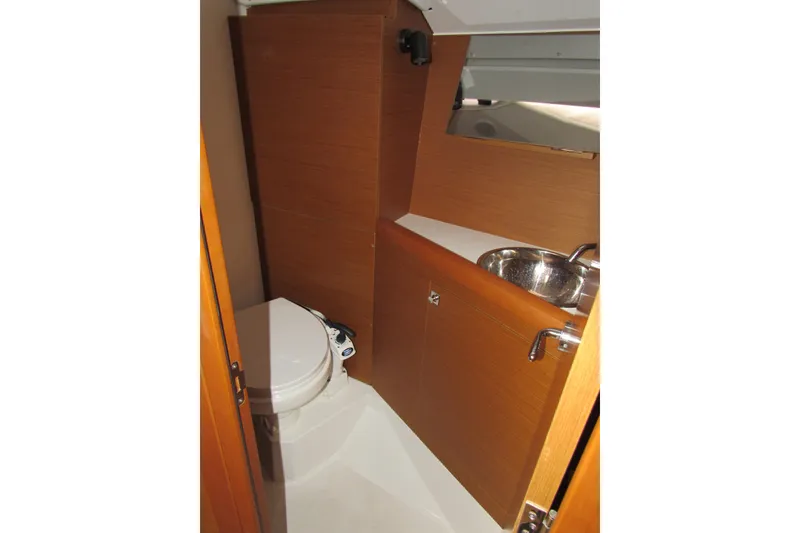 Slide: The Image of 2023 Jeanneau Sun Odyssey 349 bathroom with wooden cabinetry and stainless steel sink. - 13