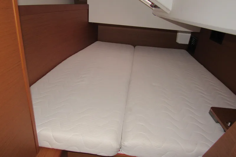 Slide: The Image of Cozy cabin bed in 2023 Jeanneau Sun Odyssey 349 sailboat interior. - 14
