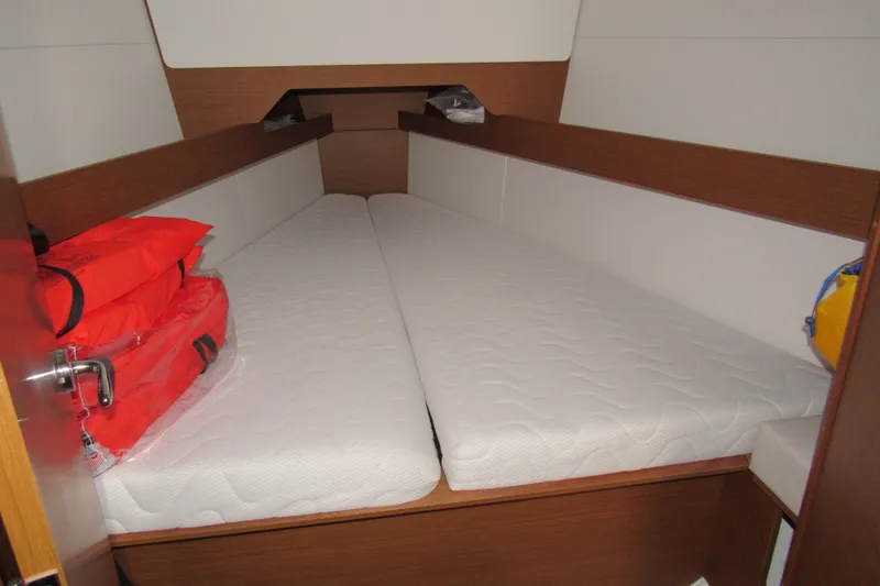Slide: The Image of Cabin interior of 2023 Jeanneau Sun Odyssey 349 with twin mattresses and life jackets. - 15