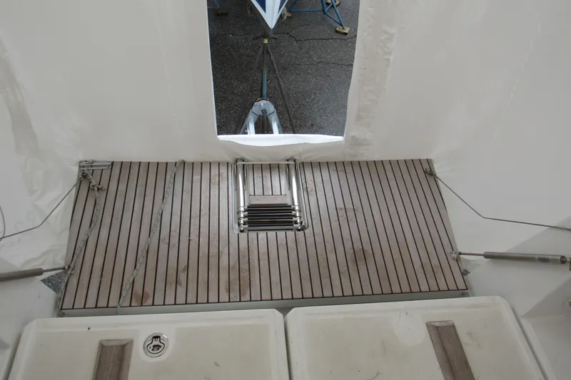Slide: The Image of 2023 Jeanneau Sun Odyssey 349 yacht deck with wooden flooring and ladder. - 20
