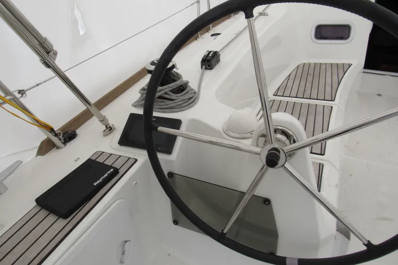 Slide: The Image of 2023 Jeanneau Sun Odyssey 349 cockpit with steering wheel and navigation equipment. - 22