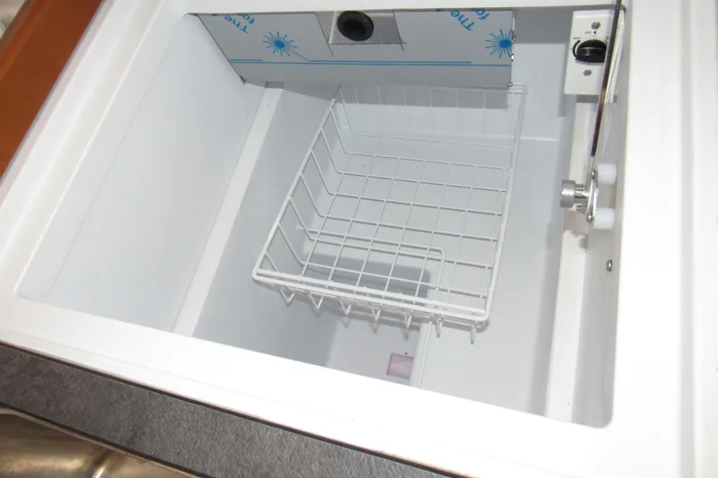 Slide: The Image of Interior view of Jeanneau Sun Odyssey 349's 2023 model refrigerator compartment. - 24