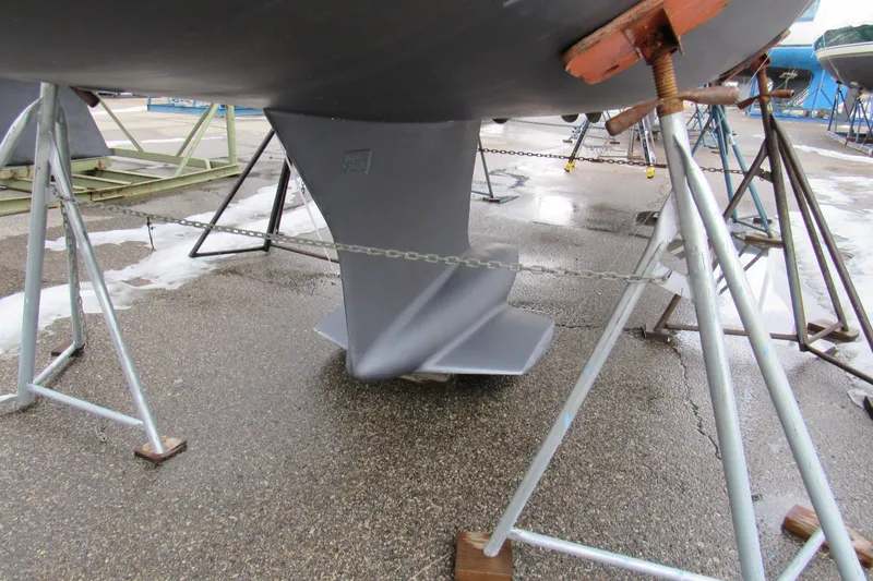 Slide: The Image of 2023 Jeanneau Sun Odyssey 349 sailboat keel on stands in a boatyard. - 4