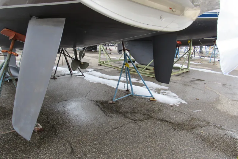 Slide: The Image of 2023 Jeanneau Sun Odyssey 349 sailboat on stands, showing keel and propeller. - 5