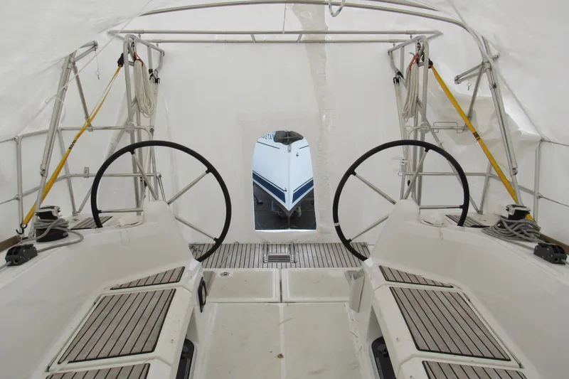 Slide: The Image of 2023 Jeanneau Sun Odyssey 349 cockpit with dual steering wheels under cover. - 6