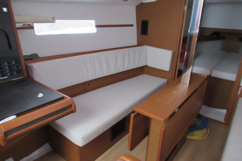 Slide: The Image of Interior of 2023 Jeanneau Sun Odyssey 349 sailboat, featuring cozy seating and modern design. - 7