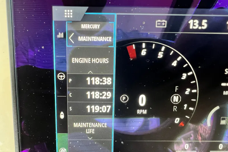 Slide: The Image of 2023 Scout 350 LXZ dashboard displaying engine hours and maintenance information. - 12