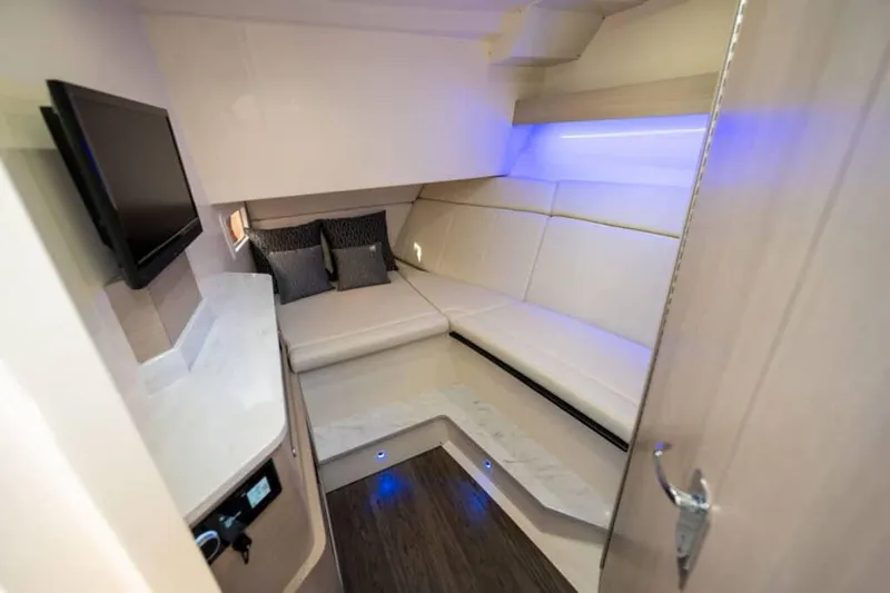Slide: The Image of Manufacturer Provided Image: 2023 Scout 350 LXZ cabin interior with white seating, TV, and ambient lighting. - 14