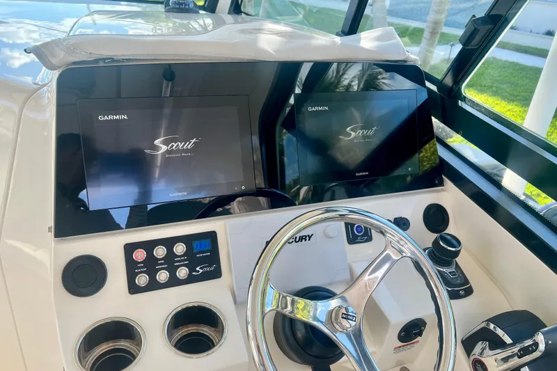 Slide: The Image of 2023 Scout 350 LXZ boat dashboard with Garmin displays and steering wheel. - 3