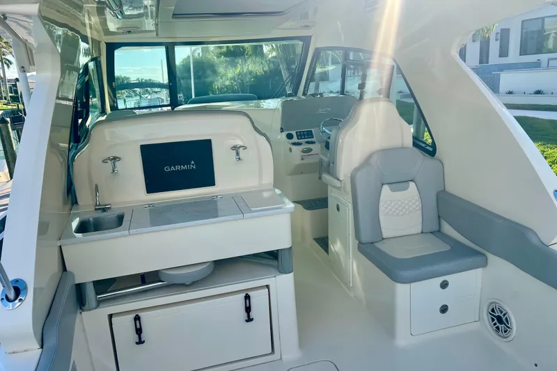 Slide: The Image of 2023 Scout 350 LXZ boat interior with Garmin system and seating area. - 6