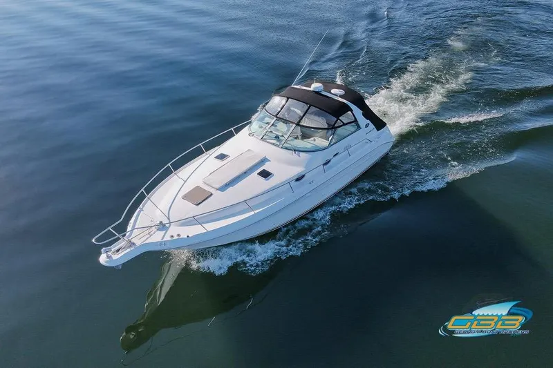 The Image of 1997 Sea Ray 330 Sundancer cruising on calm water, aerial view. - 0
