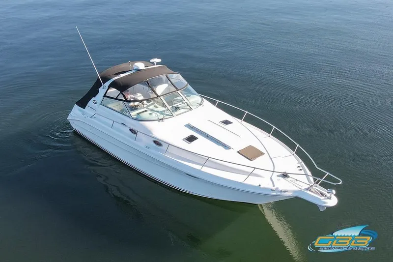 Slide: The Image of 1997 Sea Ray 330 Sundancer cruising on calm waters, aerial view. - 10