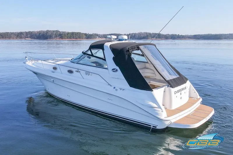 Slide: The Image of 1997 Sea Ray 330 Sundancer boat on calm water, featuring sleek design and spacious deck. - 11