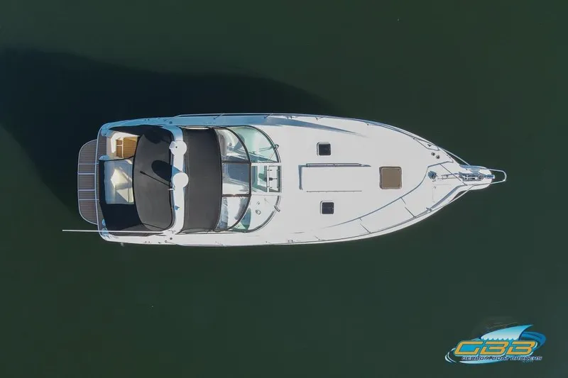 Slide: The Image of Aerial view of 1997 Sea Ray 330 Sundancer boat on calm water. - 13