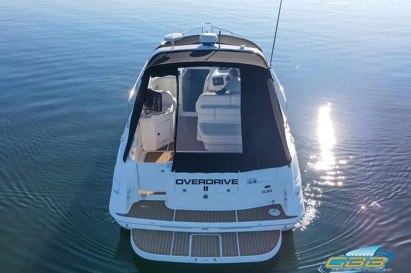 Slide: The Image of 1997 Sea Ray 330 Sundancer boat on calm water, rear view, sunny day. - 16