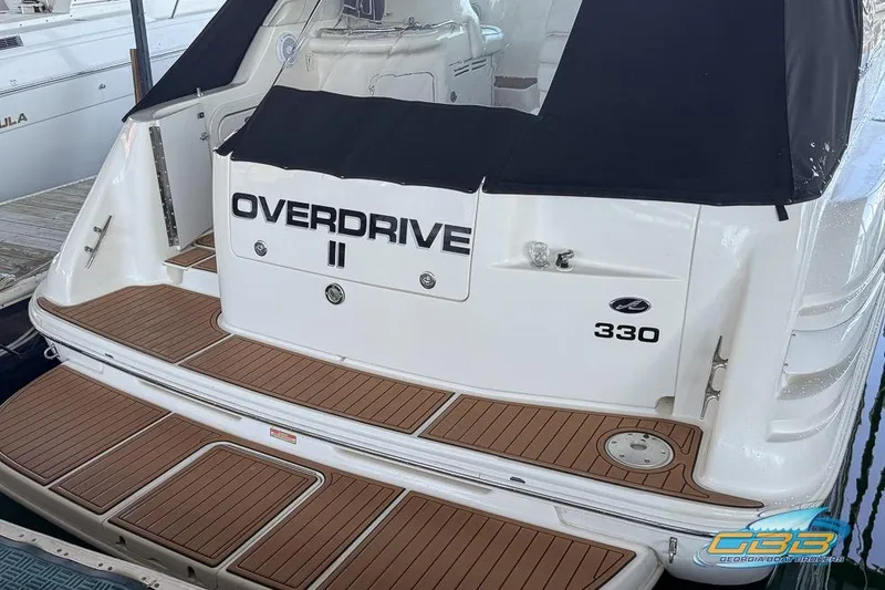 Slide: The Image of 1997 Sea Ray 330 Sundancer boat with teak deck and "Overdrive II" name. - 19