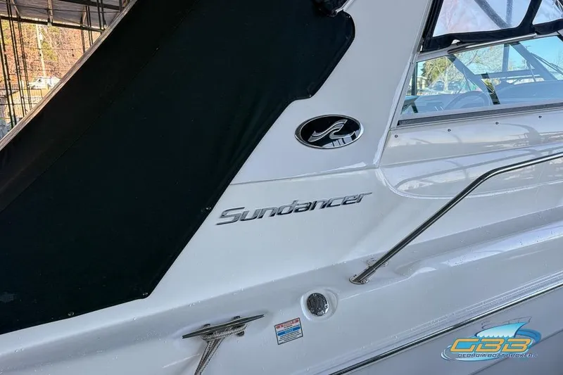 Slide: The Image of 1997 Sea Ray 330 Sundancer boat side view with logo and railing. - 20