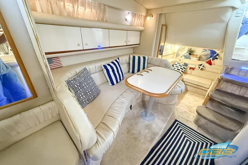 Slide: The Image of Interior of 1997 Sea Ray 330 Sundancer yacht with cozy seating and nautical decor. - 23