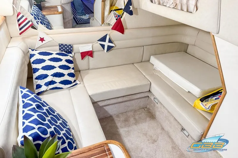 Slide: The Image of Interior of 1997 Sea Ray 330 Sundancer with nautical decor and comfortable seating. - 26