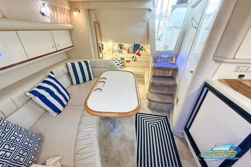 Slide: The Image of Interior of a 1997 Sea Ray 330 Sundancer yacht with cozy seating and nautical decor. - 28