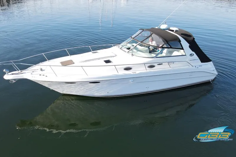 Slide: The Image of 1997 Sea Ray 330 Sundancer boat on calm water, featuring sleek white design. - 3