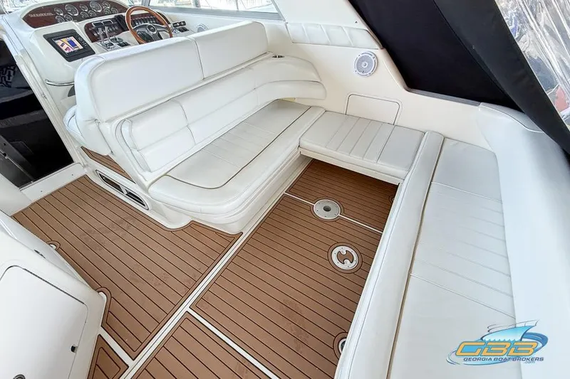 Slide: The Image of 1997 Sea Ray 330 Sundancer interior with white seating and wood-style flooring. - 39