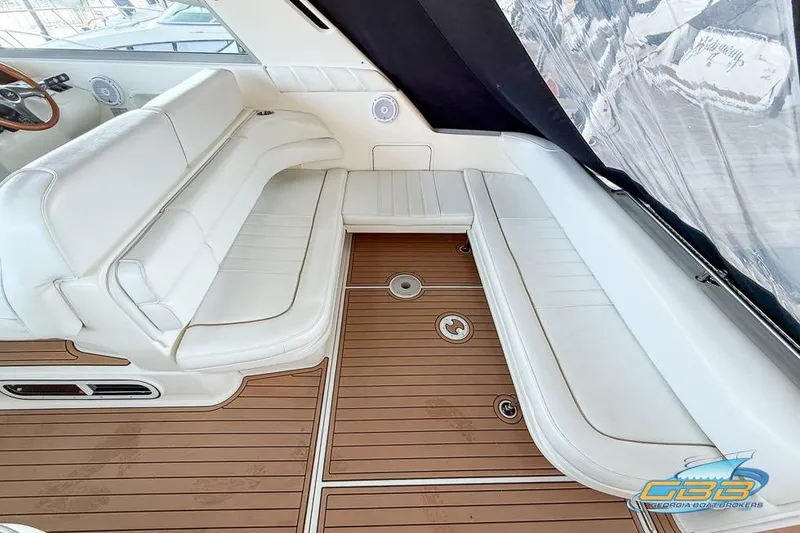 Slide: The Image of 1997 Sea Ray 330 Sundancer interior with white seating and teak flooring. - 40