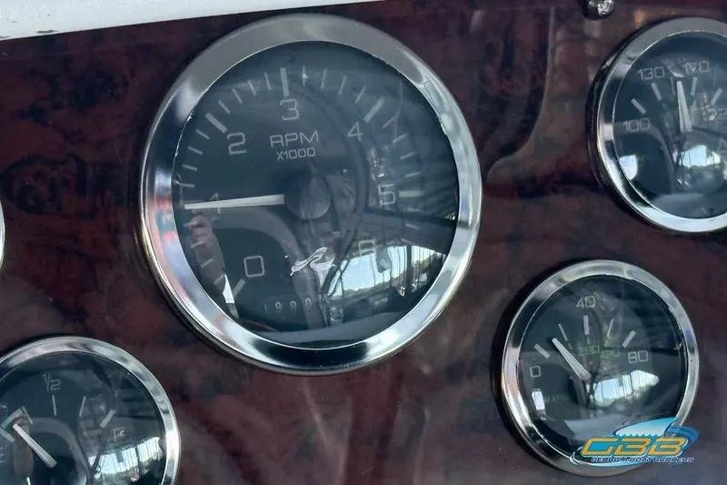 Slide: The Image of Dashboard gauges of a 1997 Sea Ray 330 Sundancer boat. - 46