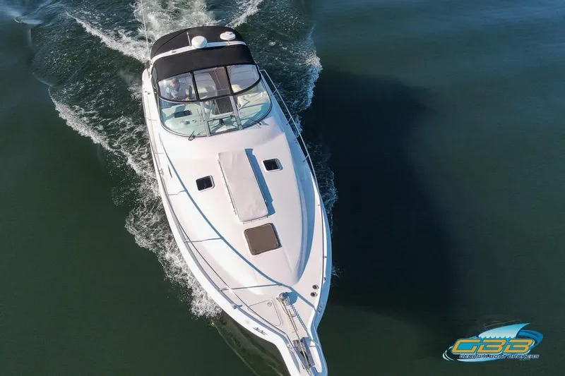 Slide: The Image of 1997 Sea Ray 330 Sundancer cruising on calm water, aerial view. - 6