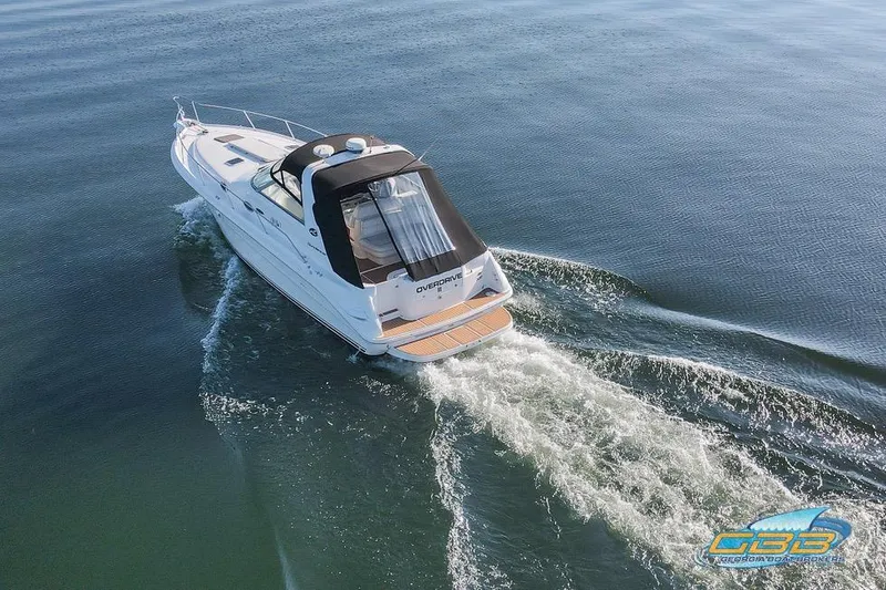 Slide: The Image of 1997 Sea Ray 330 Sundancer cruising on calm waters, aerial view. - 7