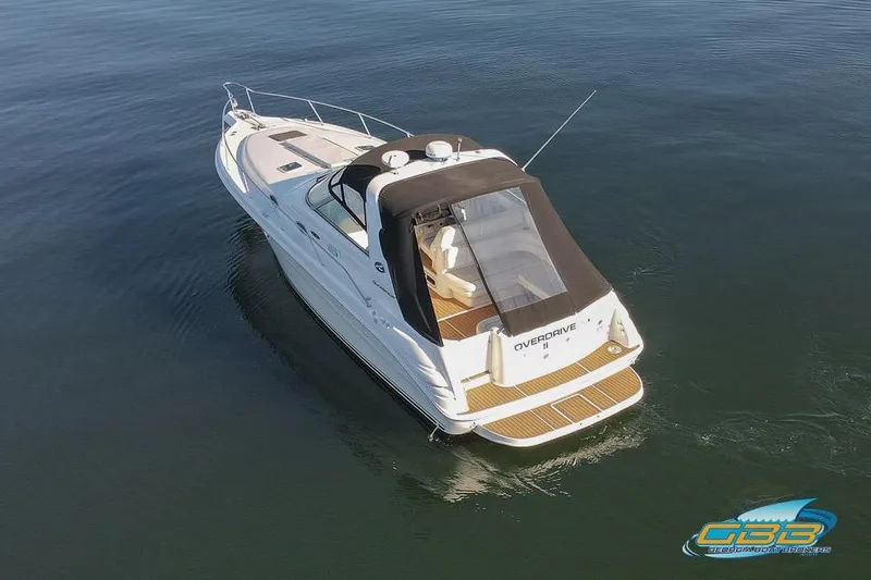 Slide: The Image of 1997 Sea Ray 330 Sundancer boat on calm water, aerial view. - 8
