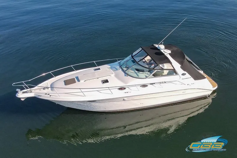 Slide: The Image of 1997 Sea Ray 330 Sundancer yacht cruising on calm waters. - 9