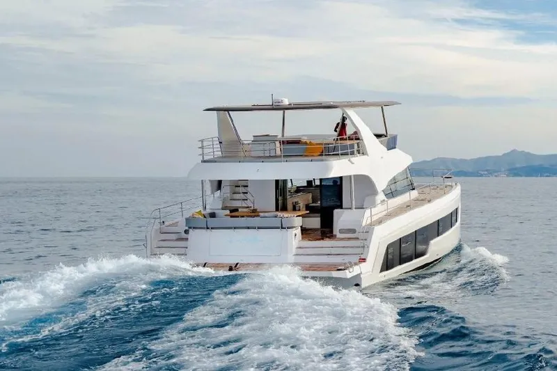 Slide: The Image of Aventura 56 Motor Yacht 2026 cruising on open sea, rear view. - 3