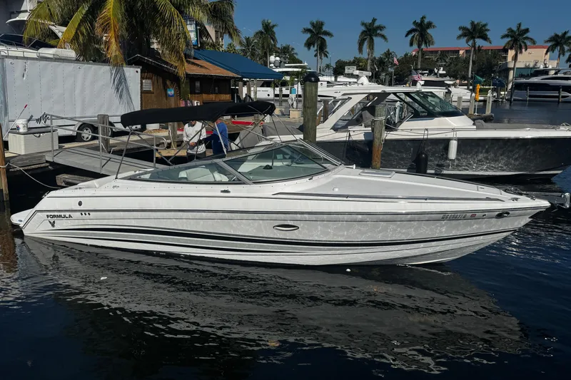 Slide: The Image of 2004 Formula 280 Sun Sport boat docked at marina with palm trees. - 1